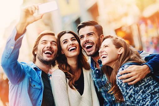 smiling people taking selfie