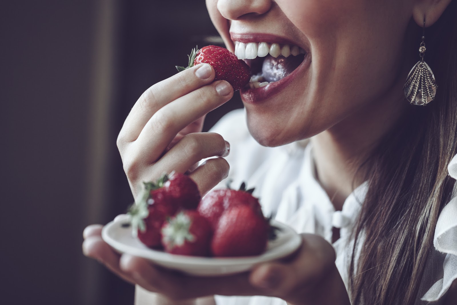 woman eating strawberries