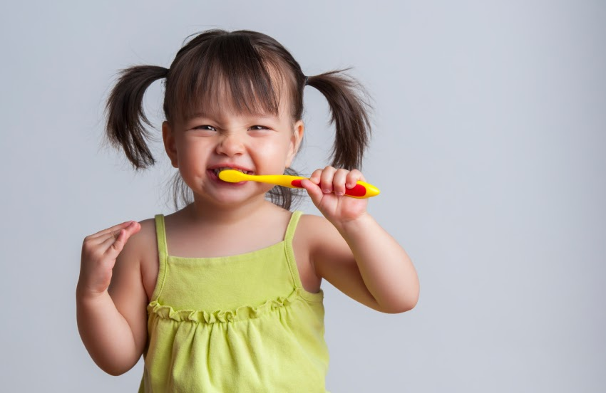 toddle girl brushing teeth